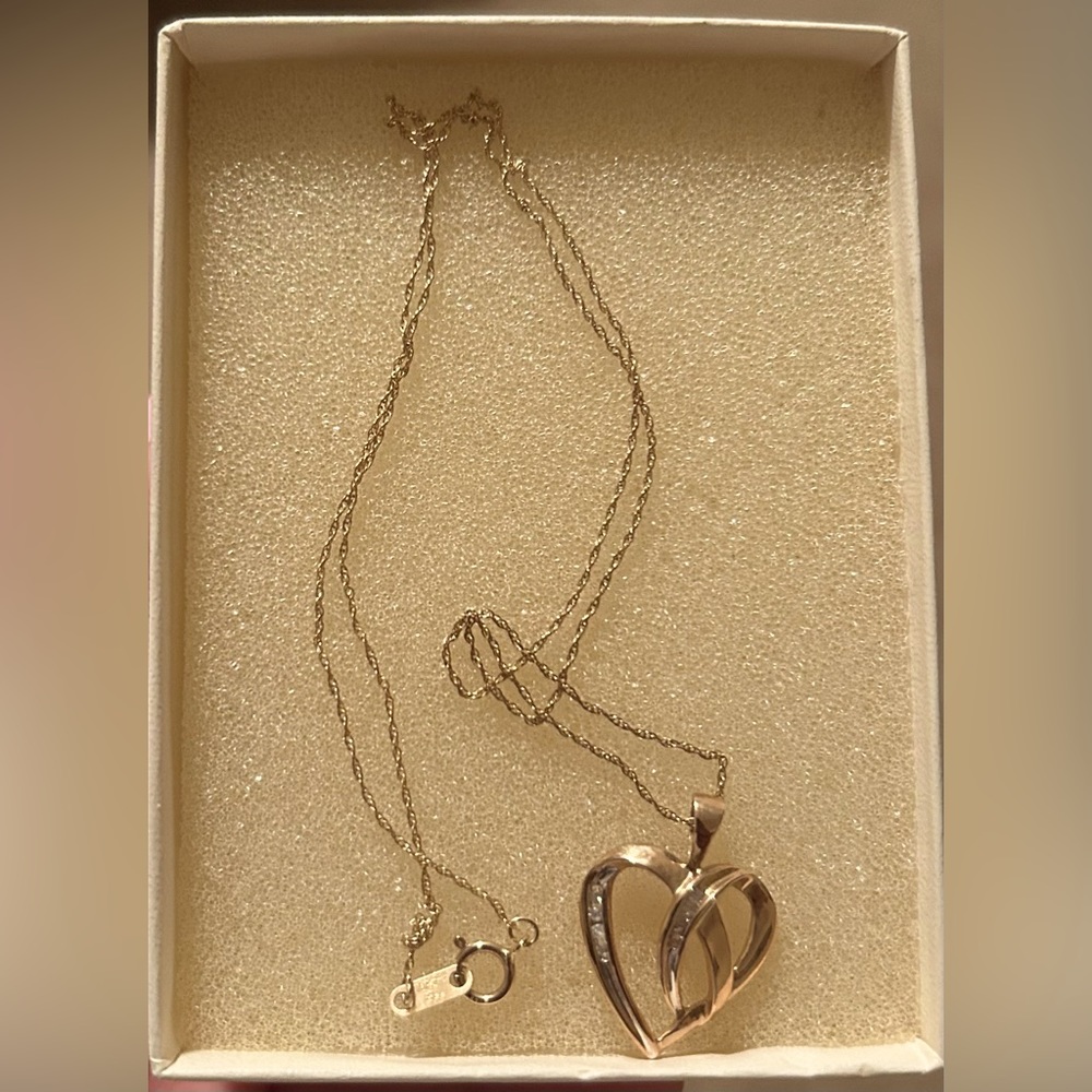 Gold heart necklace with diamonds.